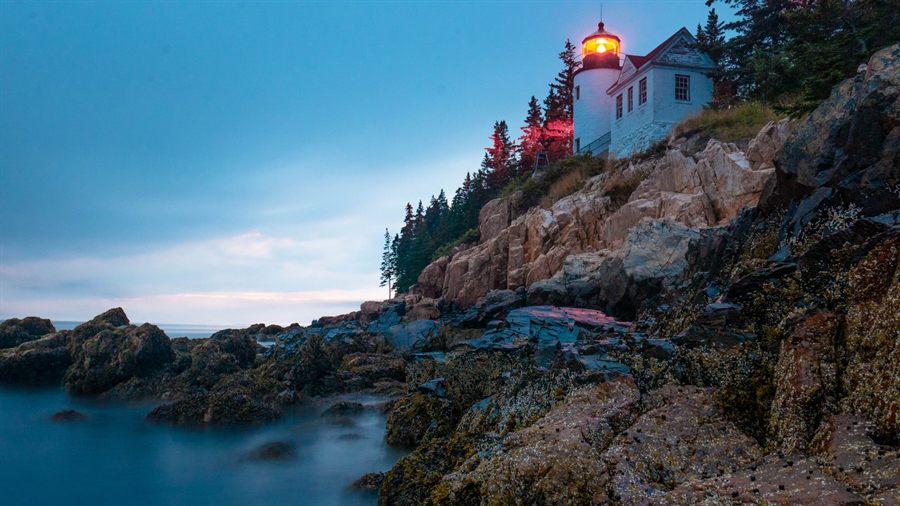 Bass Harbor Head Lighthouse on the rocky Acadia coast at sunset