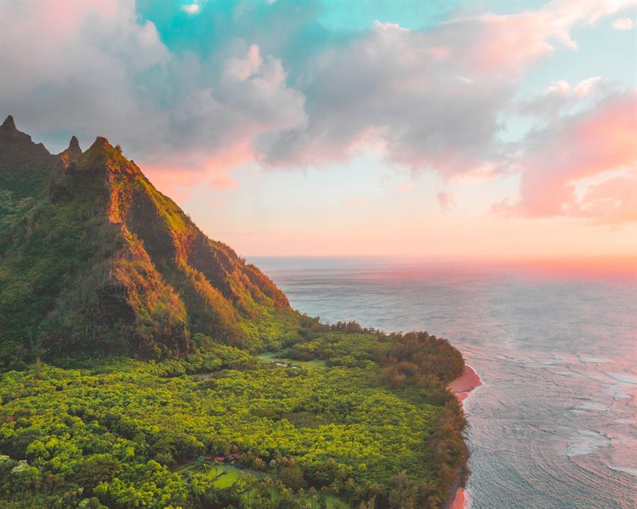 Green ridge of Kauai above the Pacific at sunset